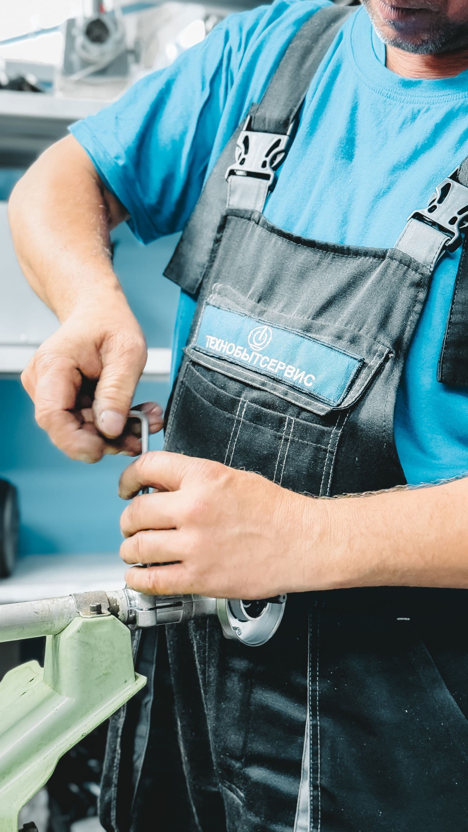 Plumber repairing pipework under a sink